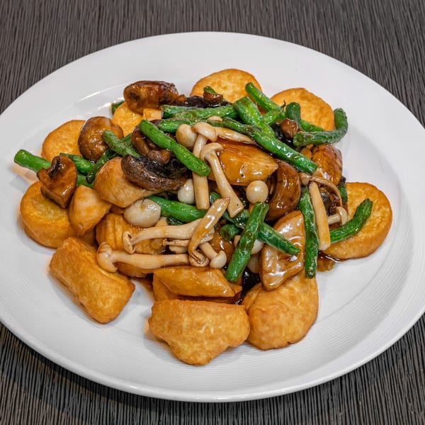 Imperial Garden's fried tofu with green beans and assorted mushrooms in a savory brown sauce.