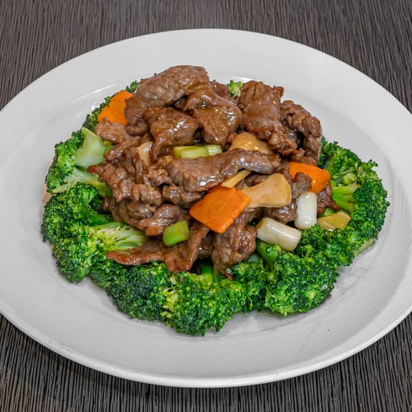 Imperial Garden's beef with broccoli, carrots, and scallions, served on a white plate.