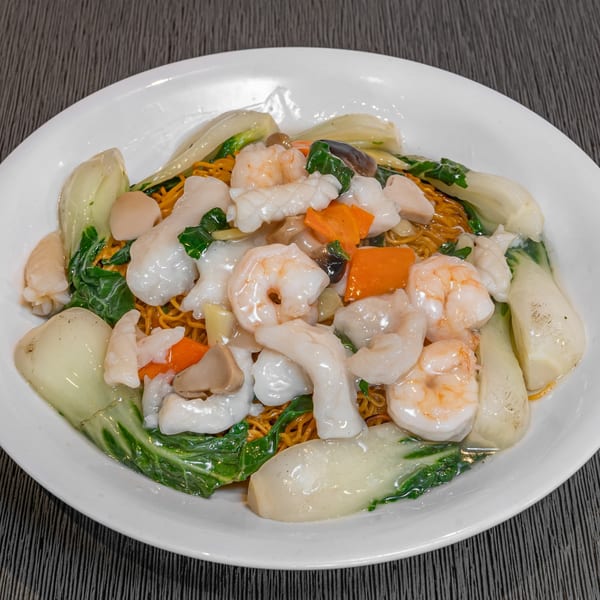 Imperial Garden's crispy noodles topped with shrimp, squid, bok choy, and carrots in a white sauce.