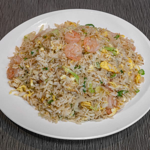 Imperial Garden's shrimp fried rice with egg, green onions, and cabbage on a white plate.